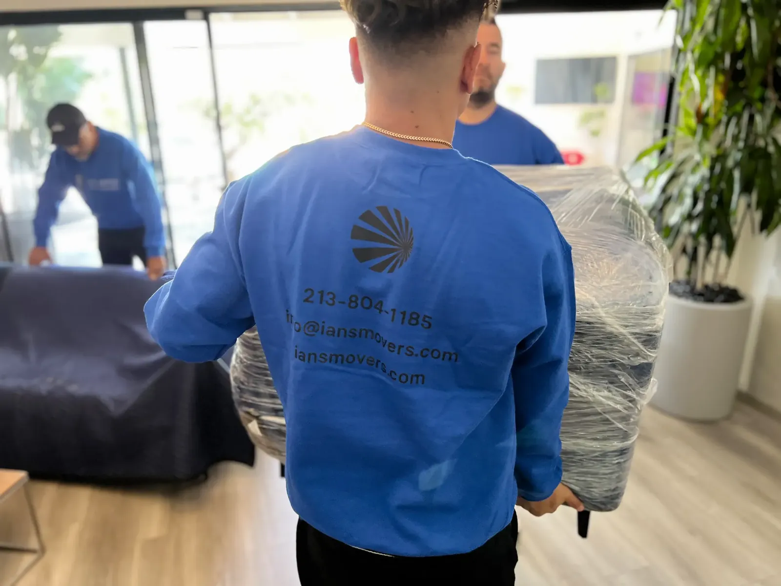Ian's Movers crew carrying a protected household item