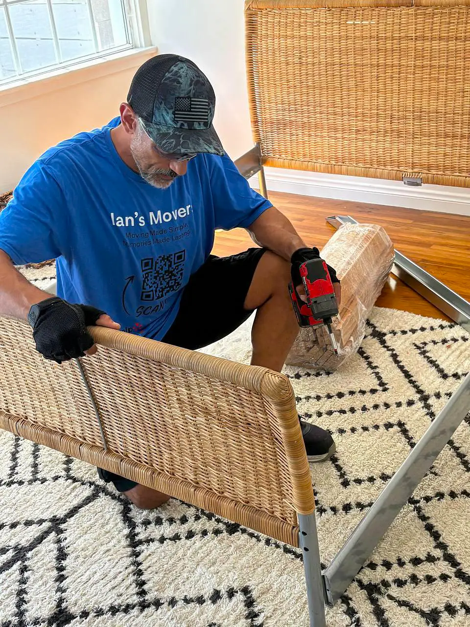 Ian's Movers mover carefully disassembling furniture during move preparation