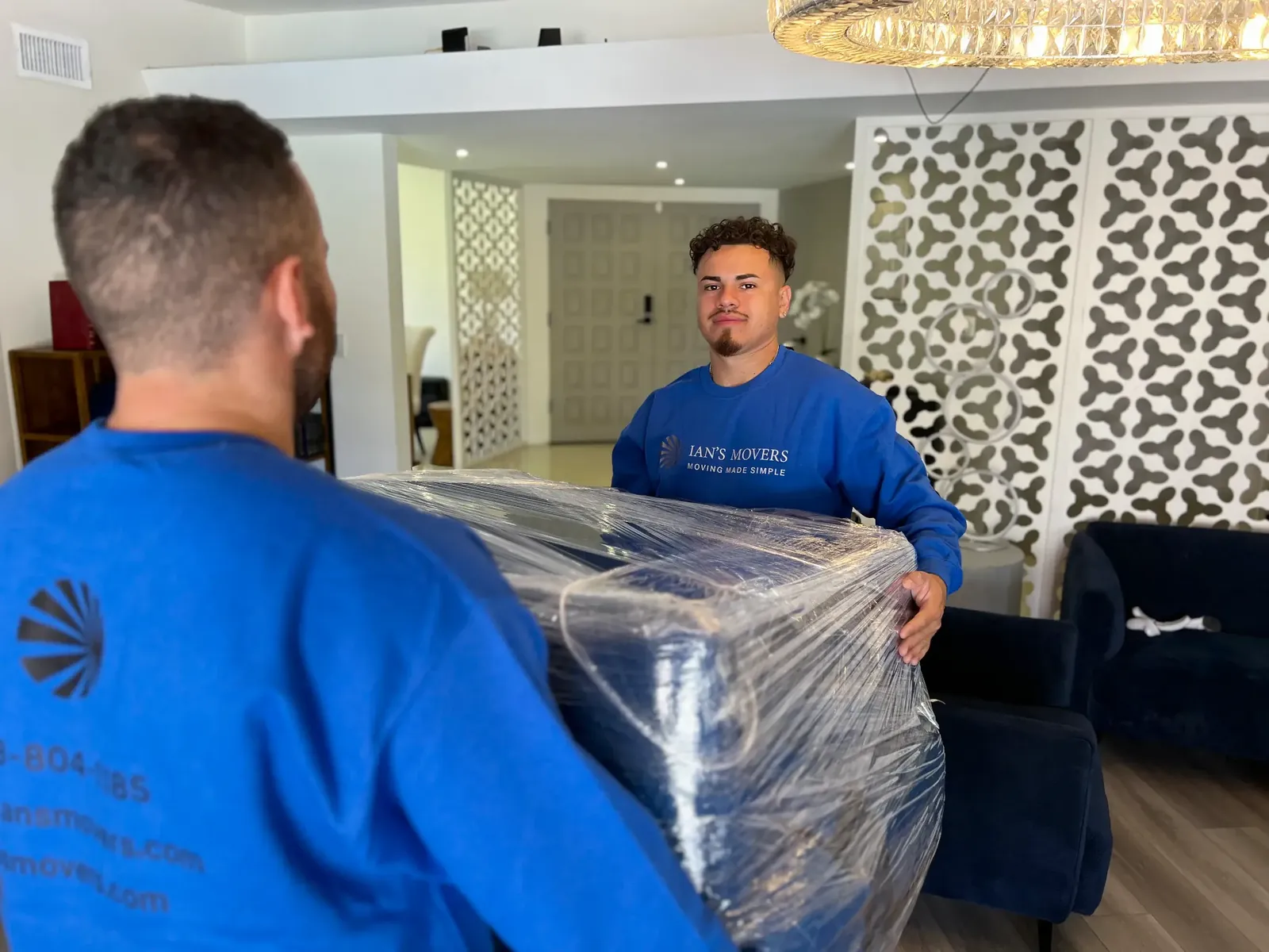 Ian's Movers crew moving protected furniture