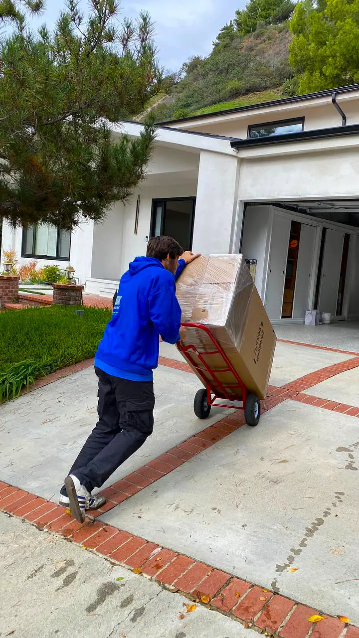 Ian's Movers crew handling protected furniture at a residence